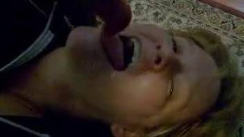 Cock sucking woman doesn't stops until the dog fills her mouth