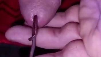 Dude jerks off holding massive worm up his dick
