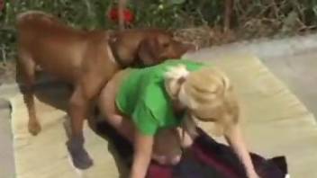 Blonde in green getting fucked by a sexy brown dog